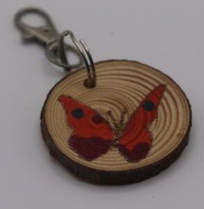 A spotted red butterfly keyring