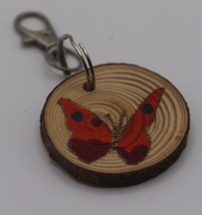 A spotted red butterfly keyring