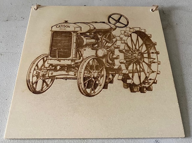 A old tractor engraved on a plaque