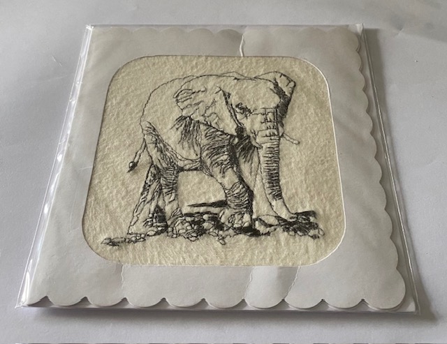 A embroidered card with a elephant on it