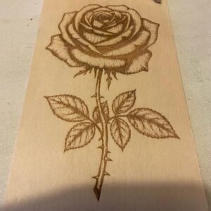 A wall plaque with a rose on itp